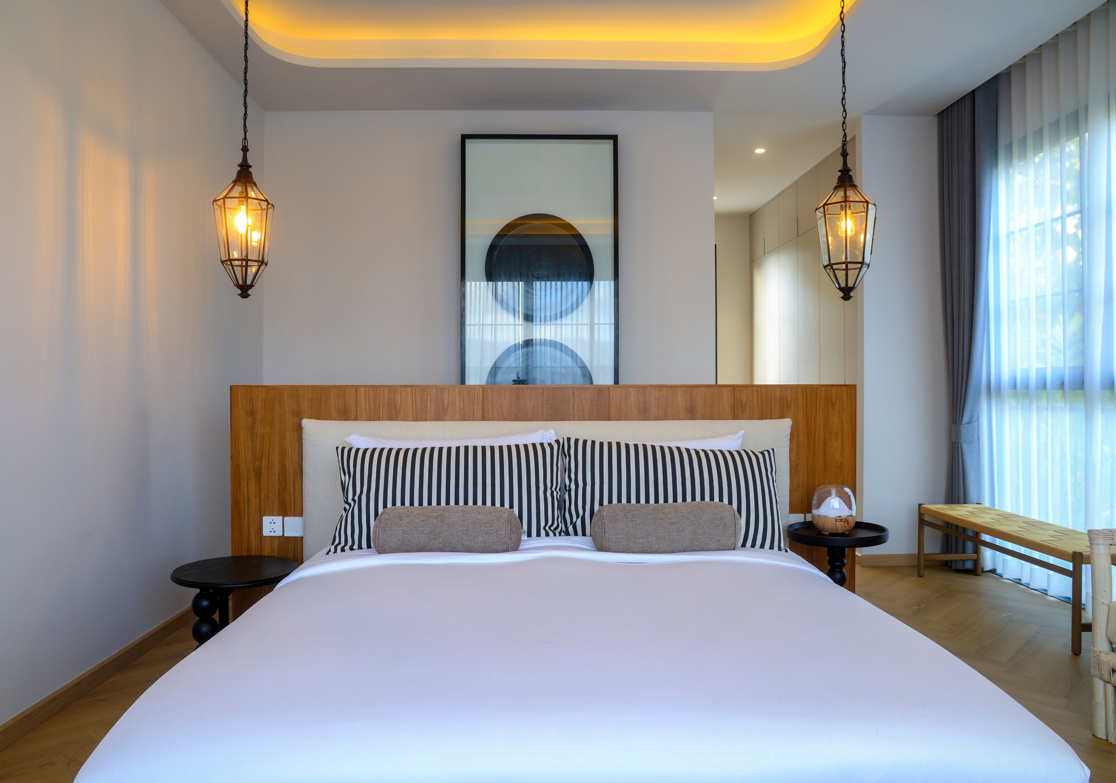 Actual Villa 04 bedroom with timber headboard and warm lighting
